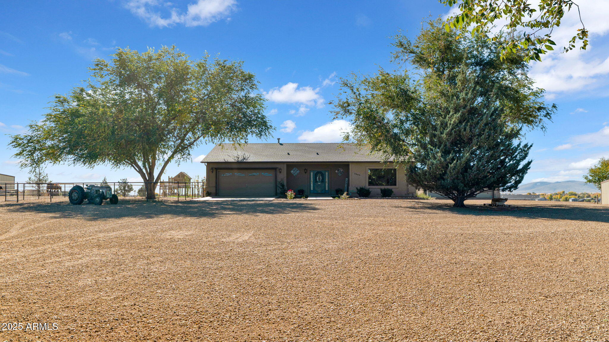 7645 Memory Lane Prescott Valley, AZ 86315 - Photo 26 of 79 a front view of house with yard and trees