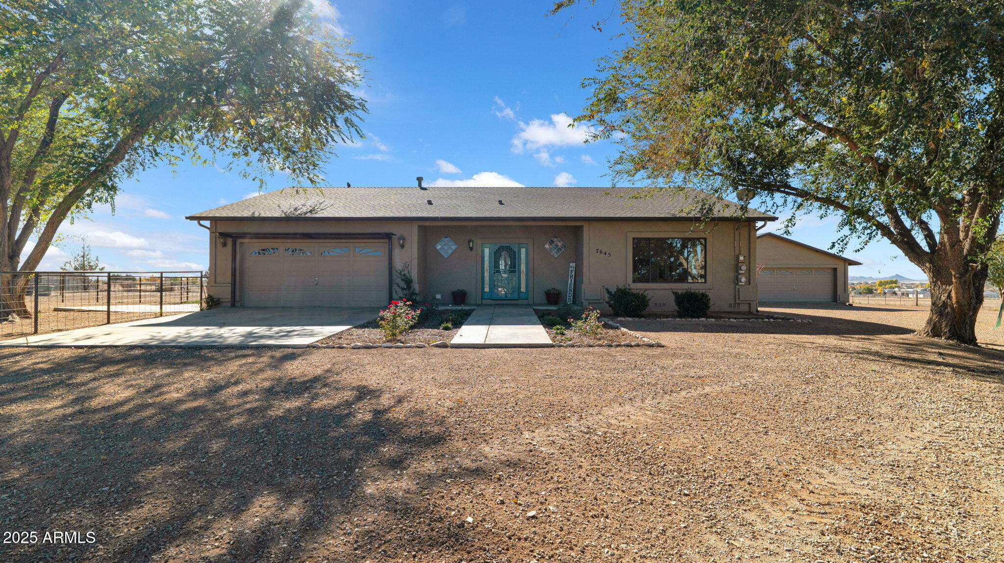 7645 Memory Lane Prescott Valley, AZ 86315 - Photo 30 of 79 a front view of a house with a yard and garage