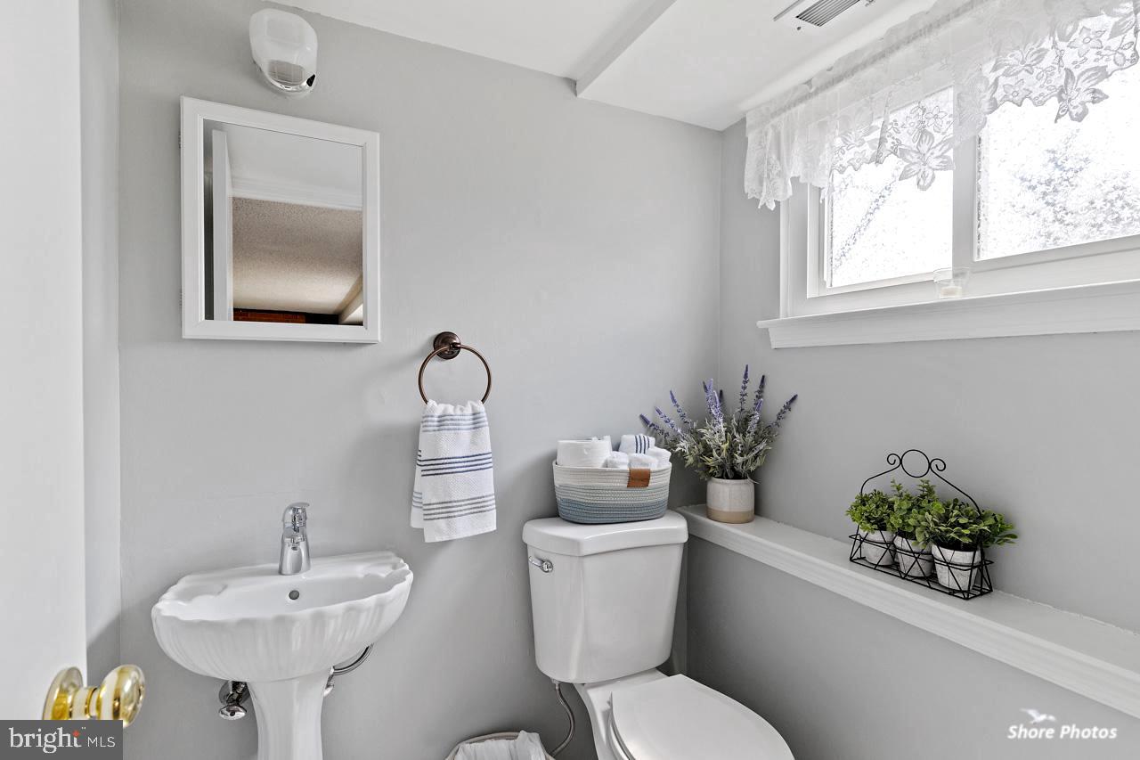 24 Cobblestone Road Cherry Hill, NJ 08003 - Photo 22 of 40 a bathroom with a toilet a sink and a window