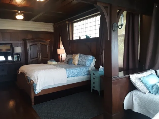 a bedroom with a bed window and couch