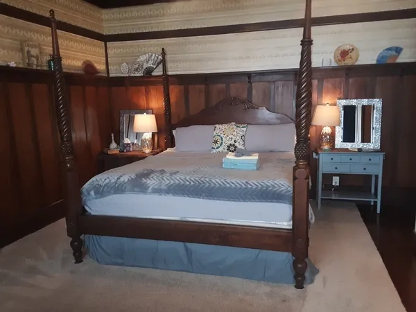 a bed sitting in a room next to a window