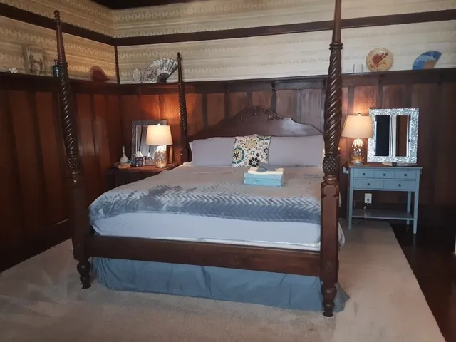 a bed sitting in a room next to a window