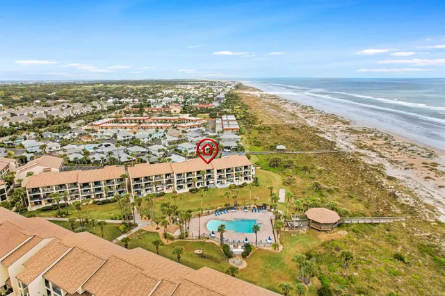 an aerial view of residential building and ocean