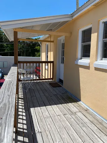 a view of a balcony with wooden floor