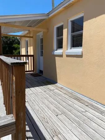 a view of a house with wooden floor and iron stairs