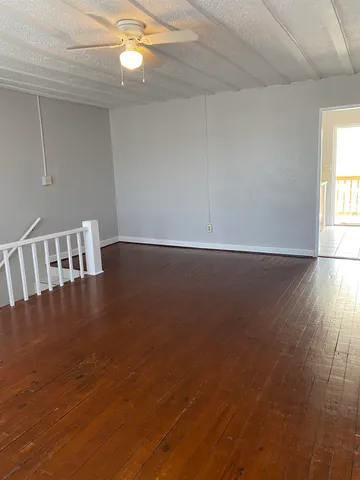 a view of wooden floor and window in a room