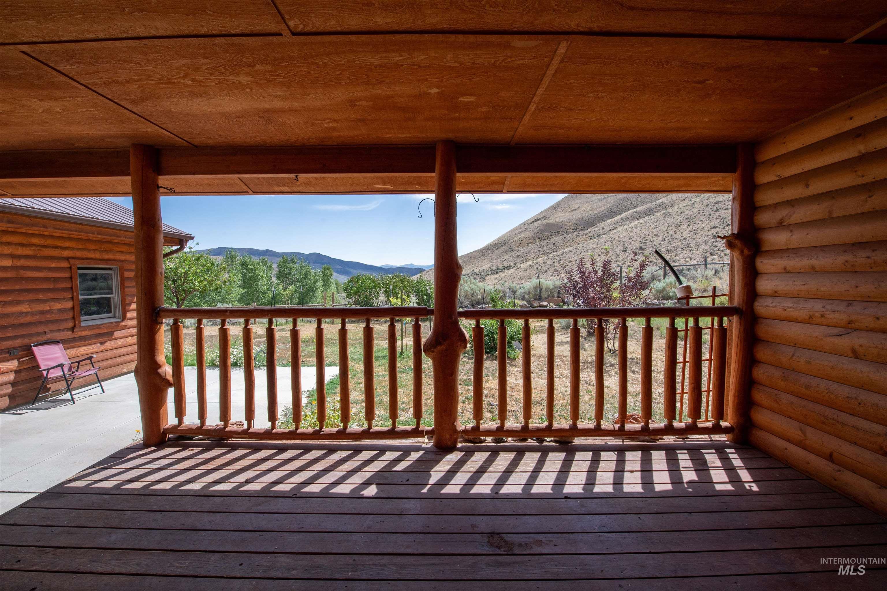 9885 Challis Creek Road Challis, ID 83226 - Photo 31 of 48 Wooden terrace featuring a mountain view