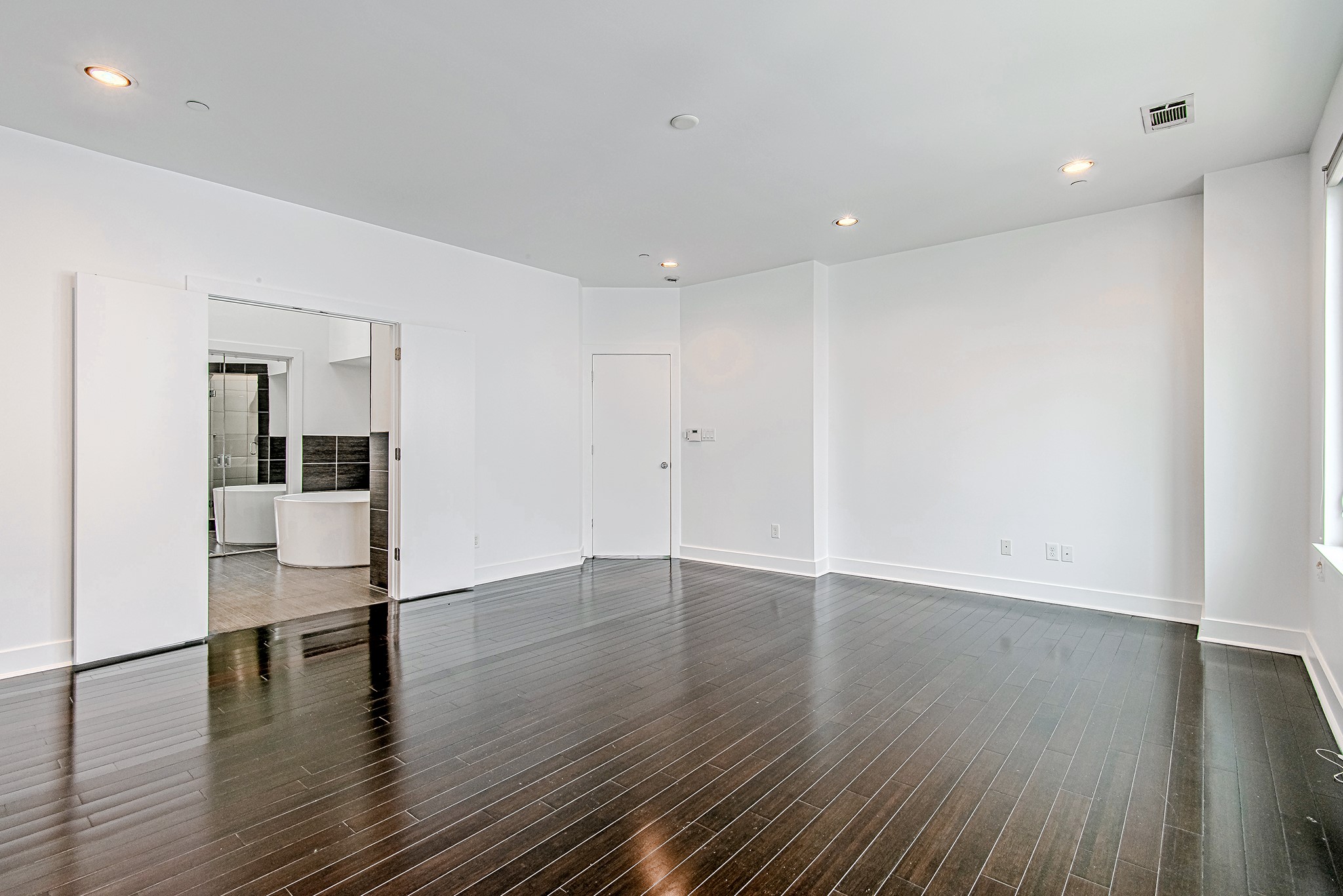 2025 Colquitt Street, Unit E Houston, TX 77098 - Photo 17 of 29 Another angle of the spacious primary bedroom with clean finishes, ideal for a variety of uses.
