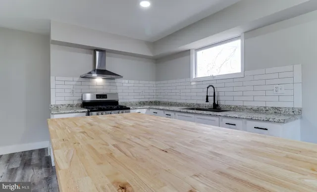 a kitchen with stainless steel appliances a sink and a stove