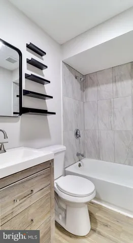 a bathroom with a toilet a sink and bathtub