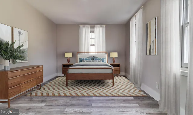 a bedroom with a bed and a potted plant