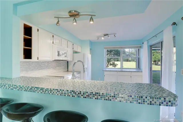 a kitchen with a sink granite top and a stove