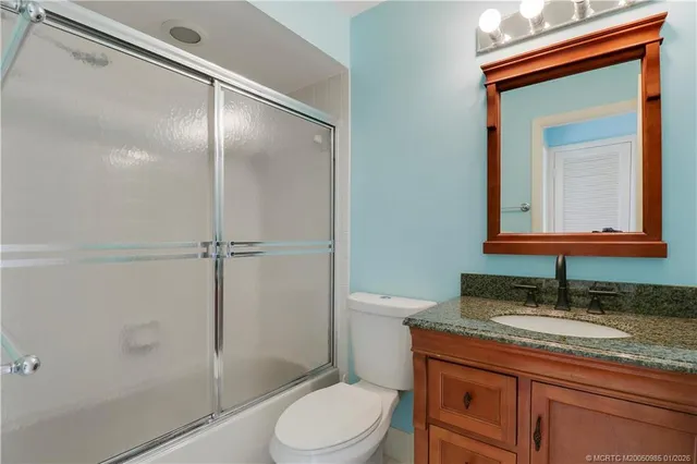a bedroom with a bed table and dresser