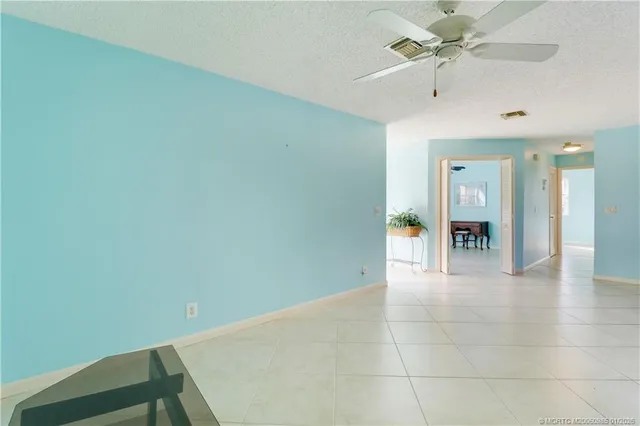 a living room with furniture and large windows