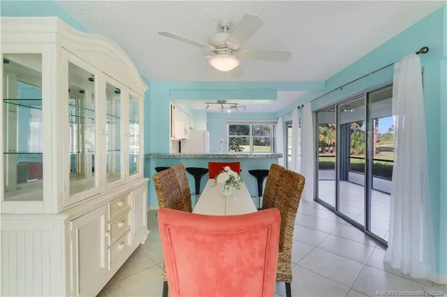 a kitchen with white cabinets and refrigerator