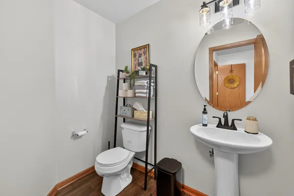 a bathroom with a toilet sink and mirror