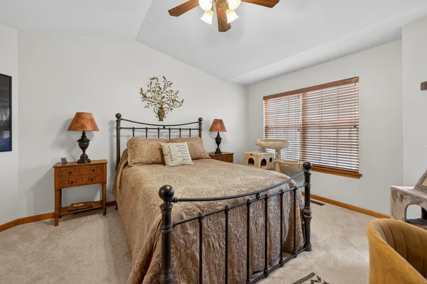 a bedroom with a bed and a chandelier