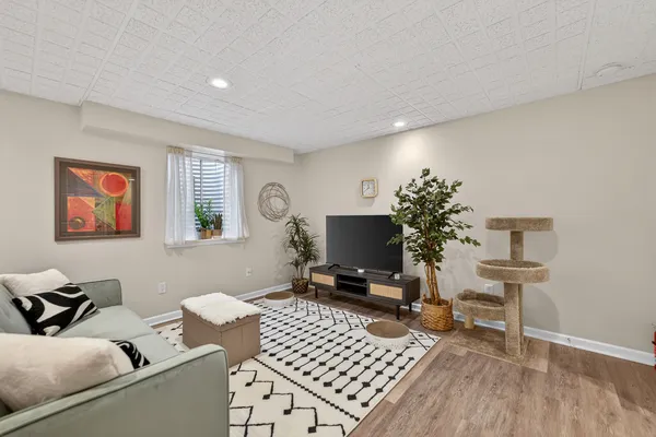 a living room with furniture a rug and a window