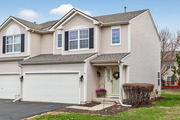 a view of a house with a yard and garage