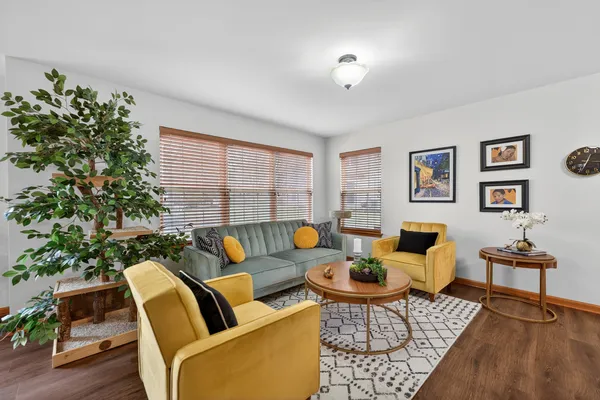 a living room with furniture and a potted plant