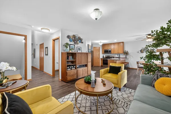 a living room with fireplace furniture and a wooden floor