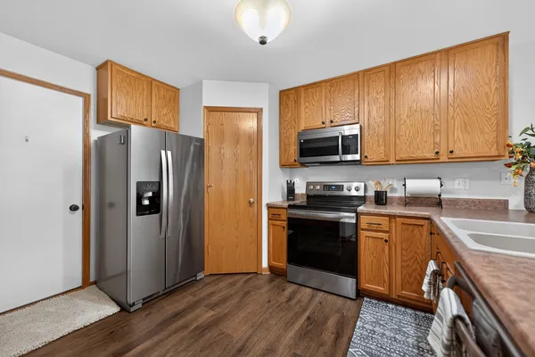 a kitchen with stainless steel appliances granite countertop a refrigerator stove and sink