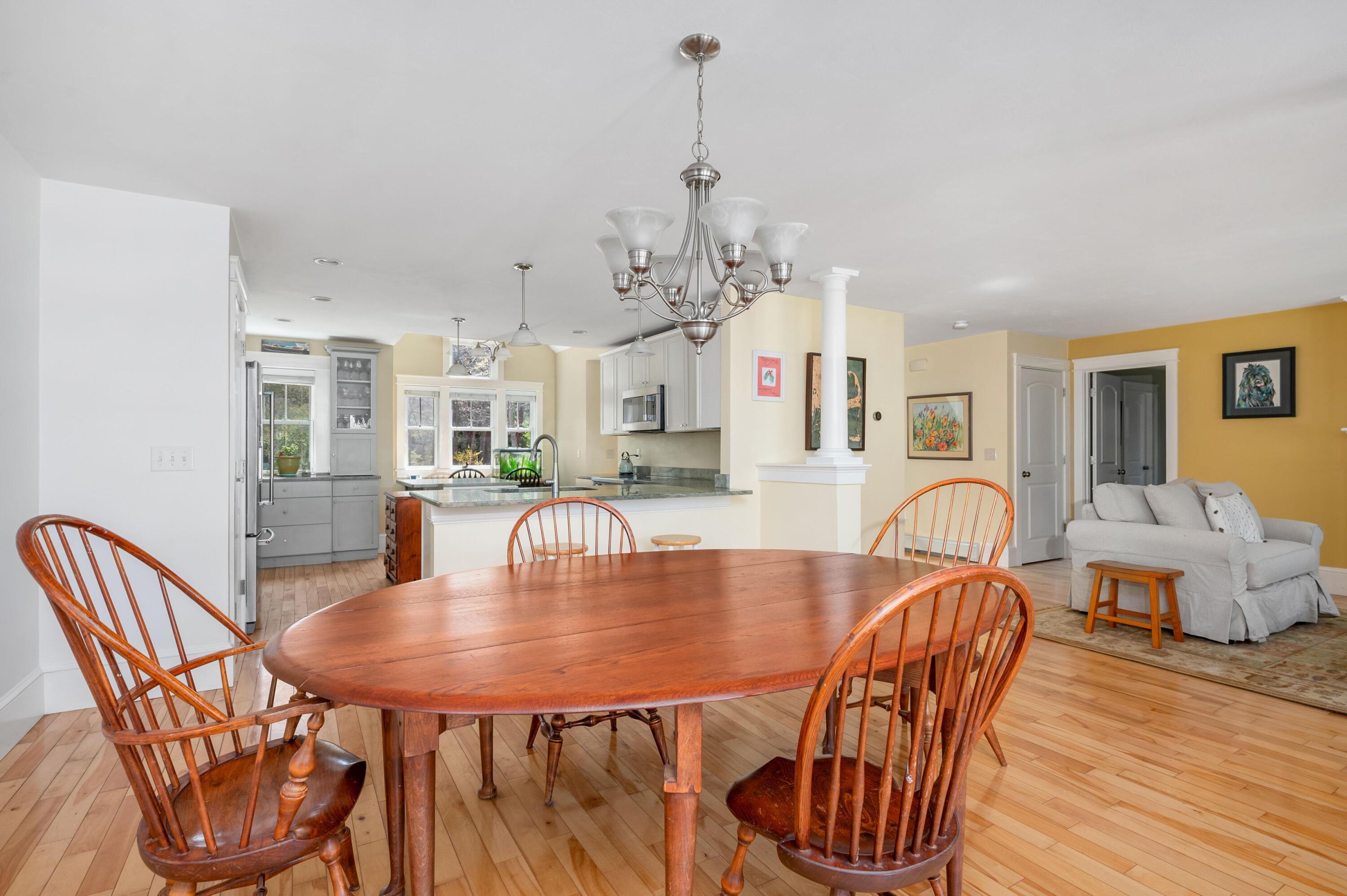 110 Clamshell Cove Road Cotuit, MA 02635 - Photo 16 of 56 a dining room with furniture a chandelier and wooden floor