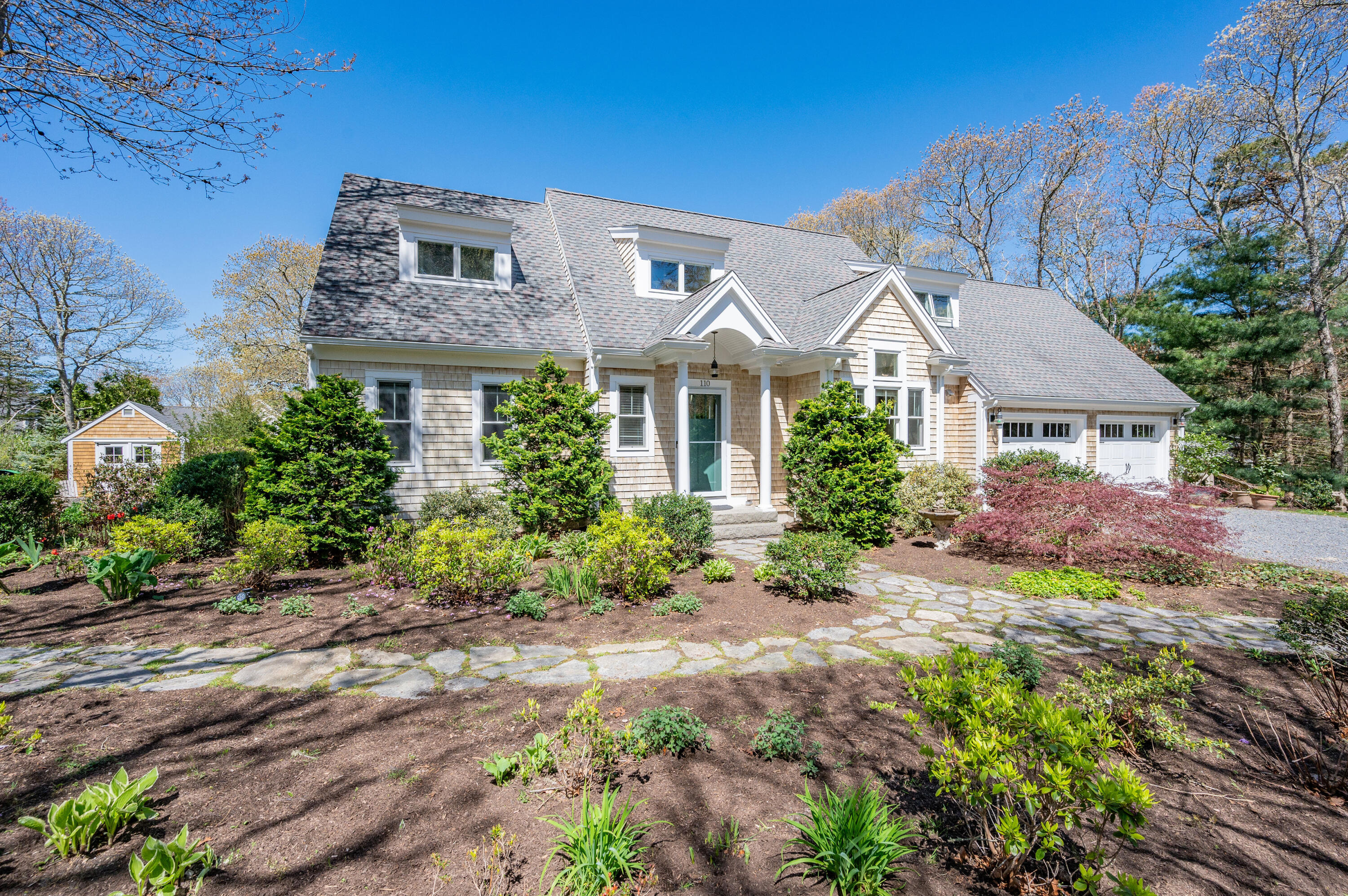 110 Clamshell Cove Road Cotuit, MA 02635 - Photo 2 of 56 a front view of a house with a yard