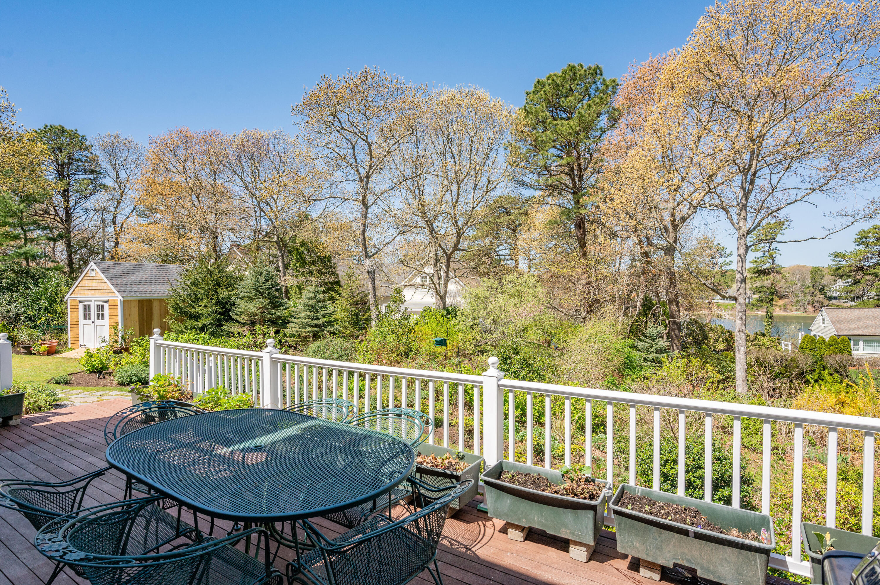 110 Clamshell Cove Road Cotuit, MA 02635 - Photo 37 of 56 a view of a chair and table on the deck