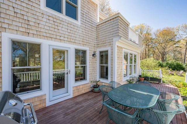 an aerial view of residential houses with outdoor space and lake view