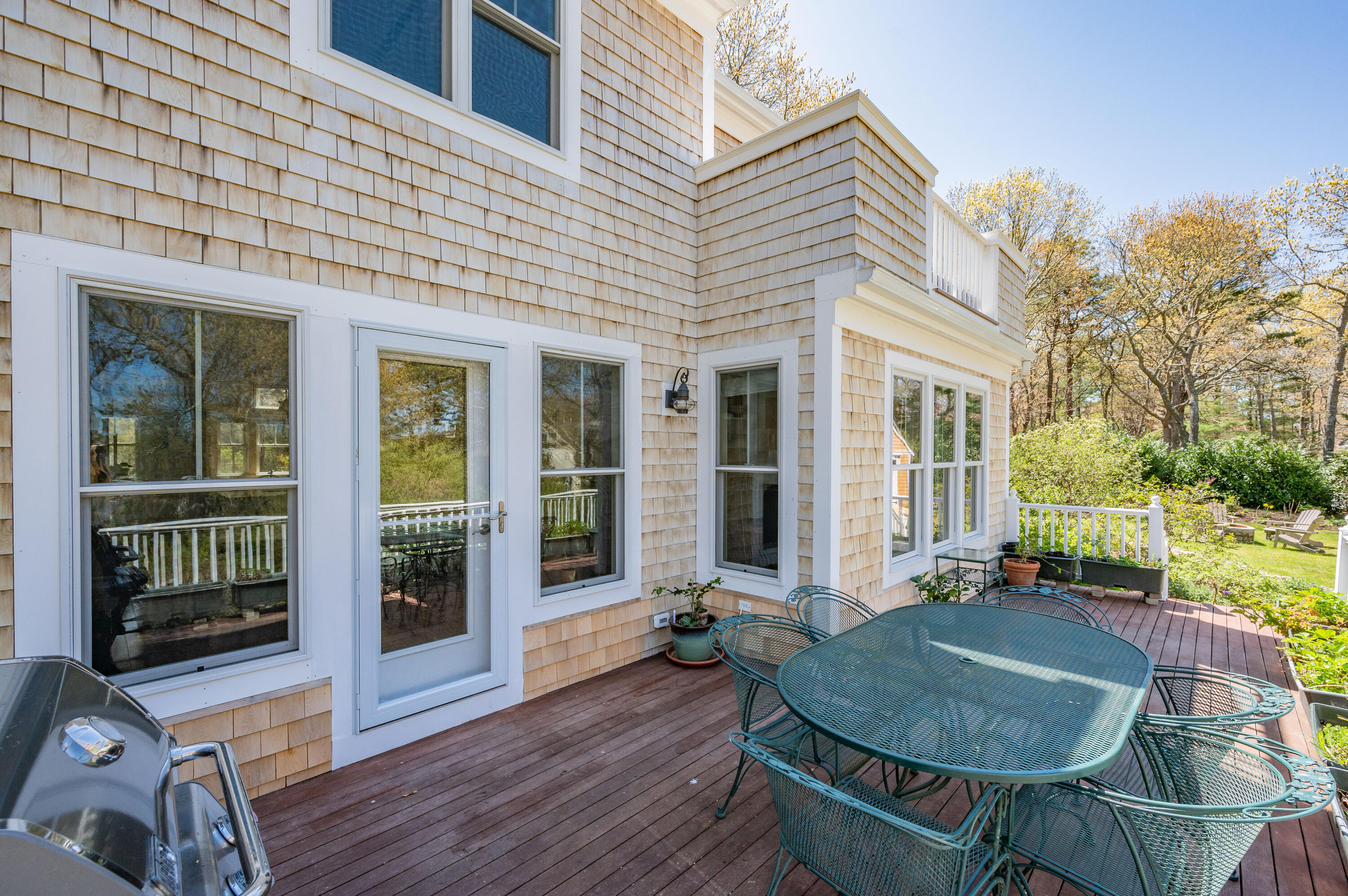 110 Clamshell Cove Road Cotuit, MA 02635 - Photo 38 of 56 a backyard of a house with yard table and chairs
