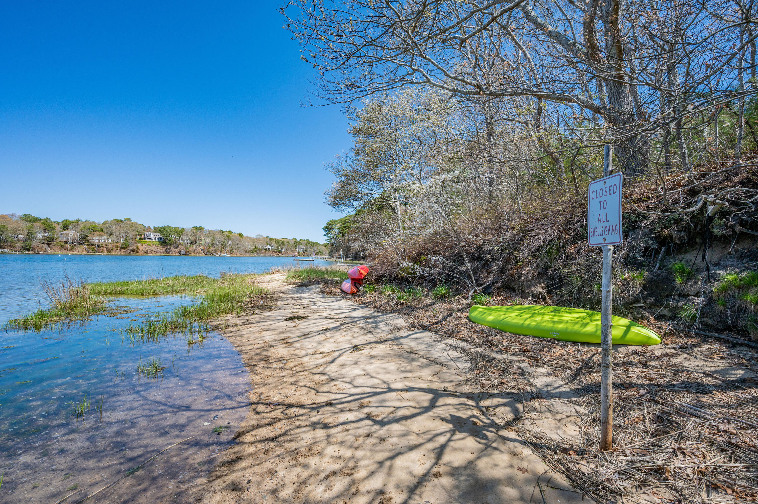 110 Clamshell Cove Road Cotuit, MA 02635 - Photo 40 of 56 a view of a lake with houses in back
