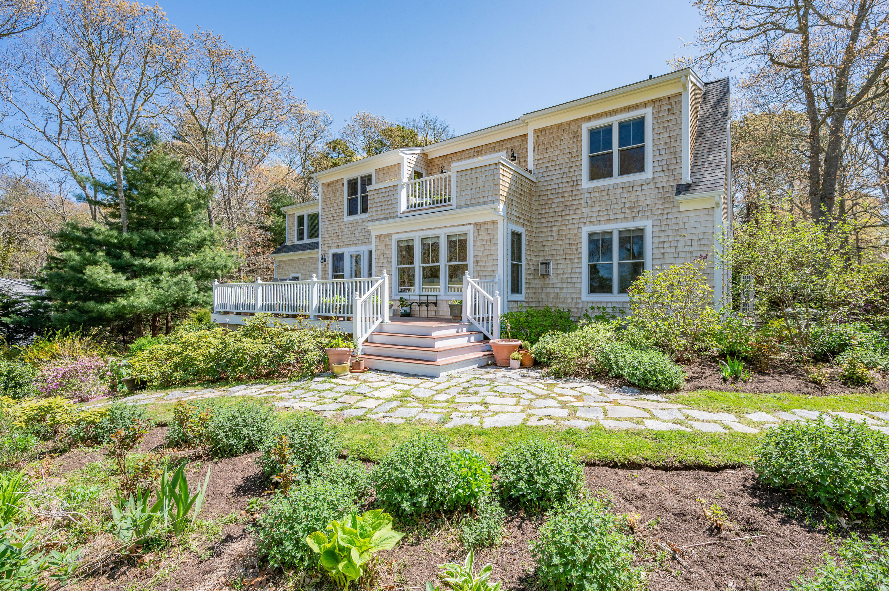 110 Clamshell Cove Road Cotuit, MA 02635 - Photo 4 of 56 a view of a house with a garden and pathway