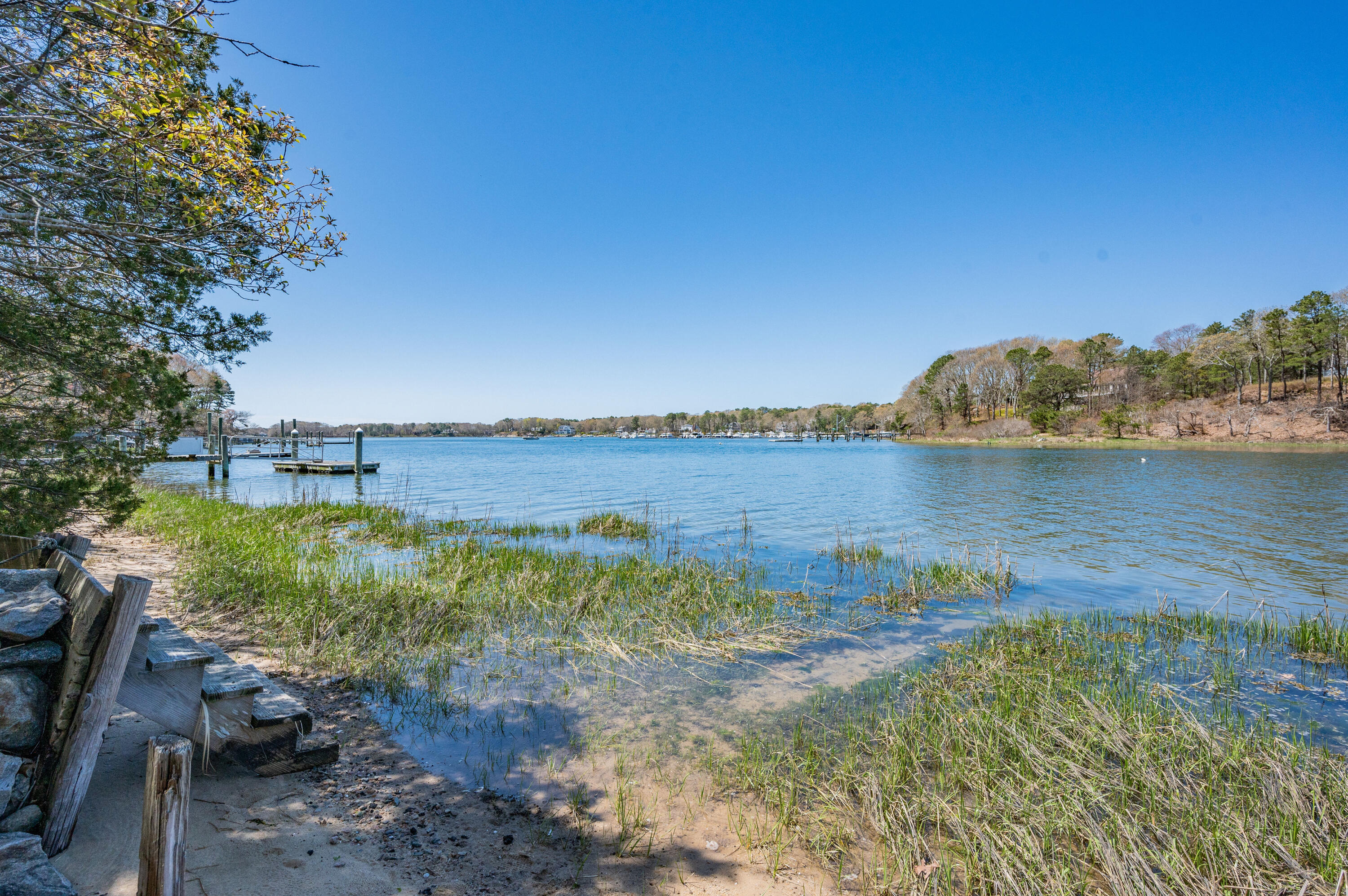 110 Clamshell Cove Road Cotuit, MA 02635 - Photo 41 of 56 a view of a lake with houses in the back