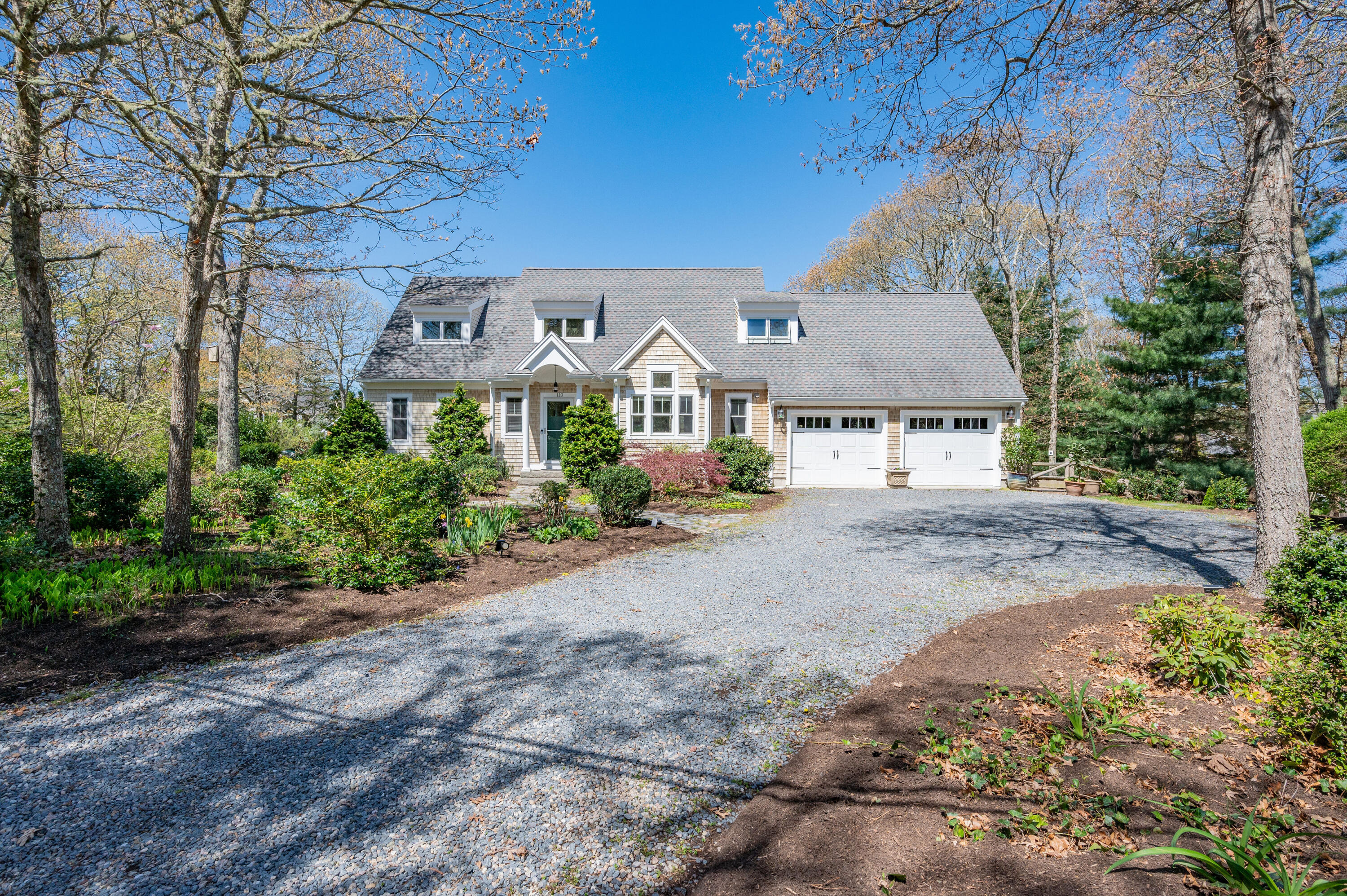 110 Clamshell Cove Road Cotuit, MA 02635 - Photo 52 of 56 a front view of a house with a yard and tree s