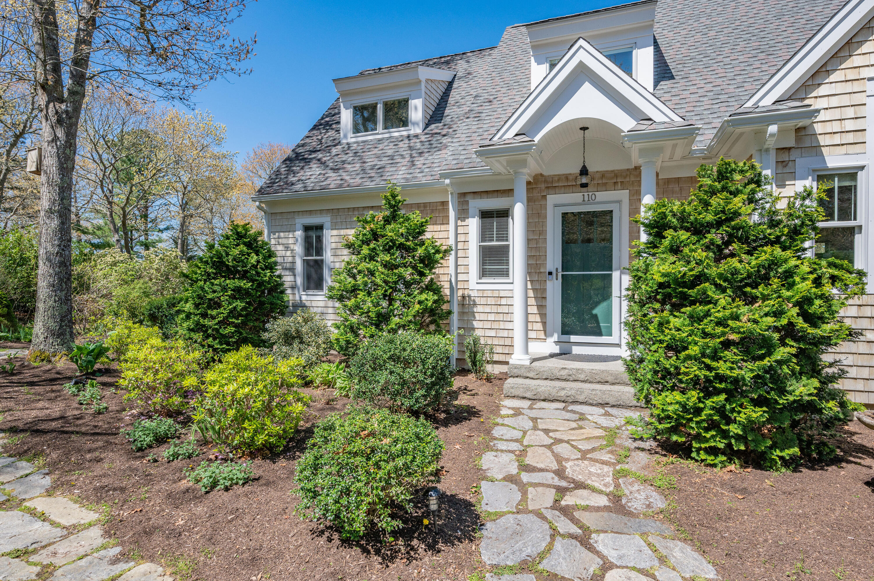 110 Clamshell Cove Road Cotuit, MA 02635 - Photo 53 of 56 a front view of a house with garden