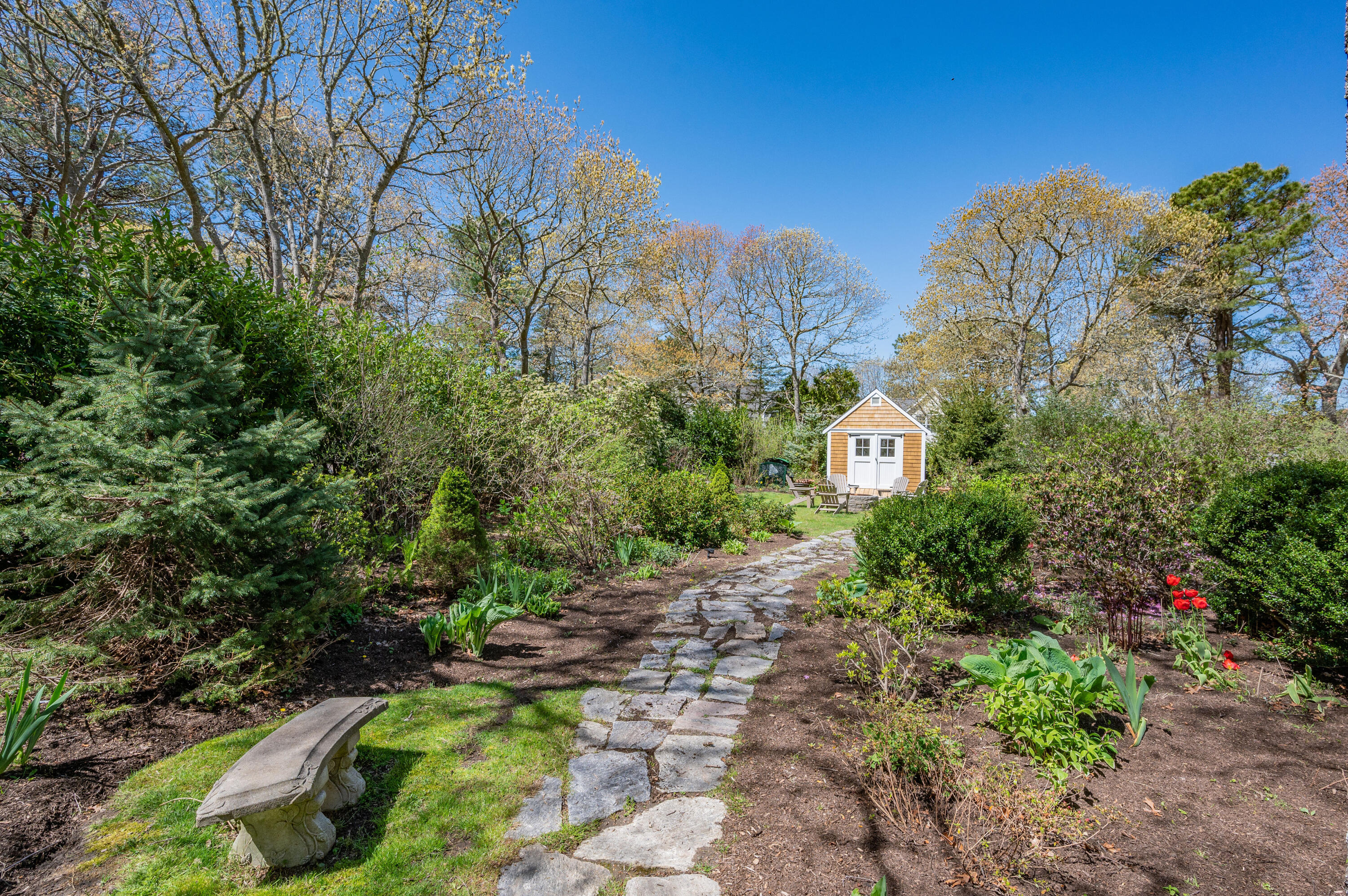 110 Clamshell Cove Road Cotuit, MA 02635 - Photo 56 of 56 a view of a garden with a house