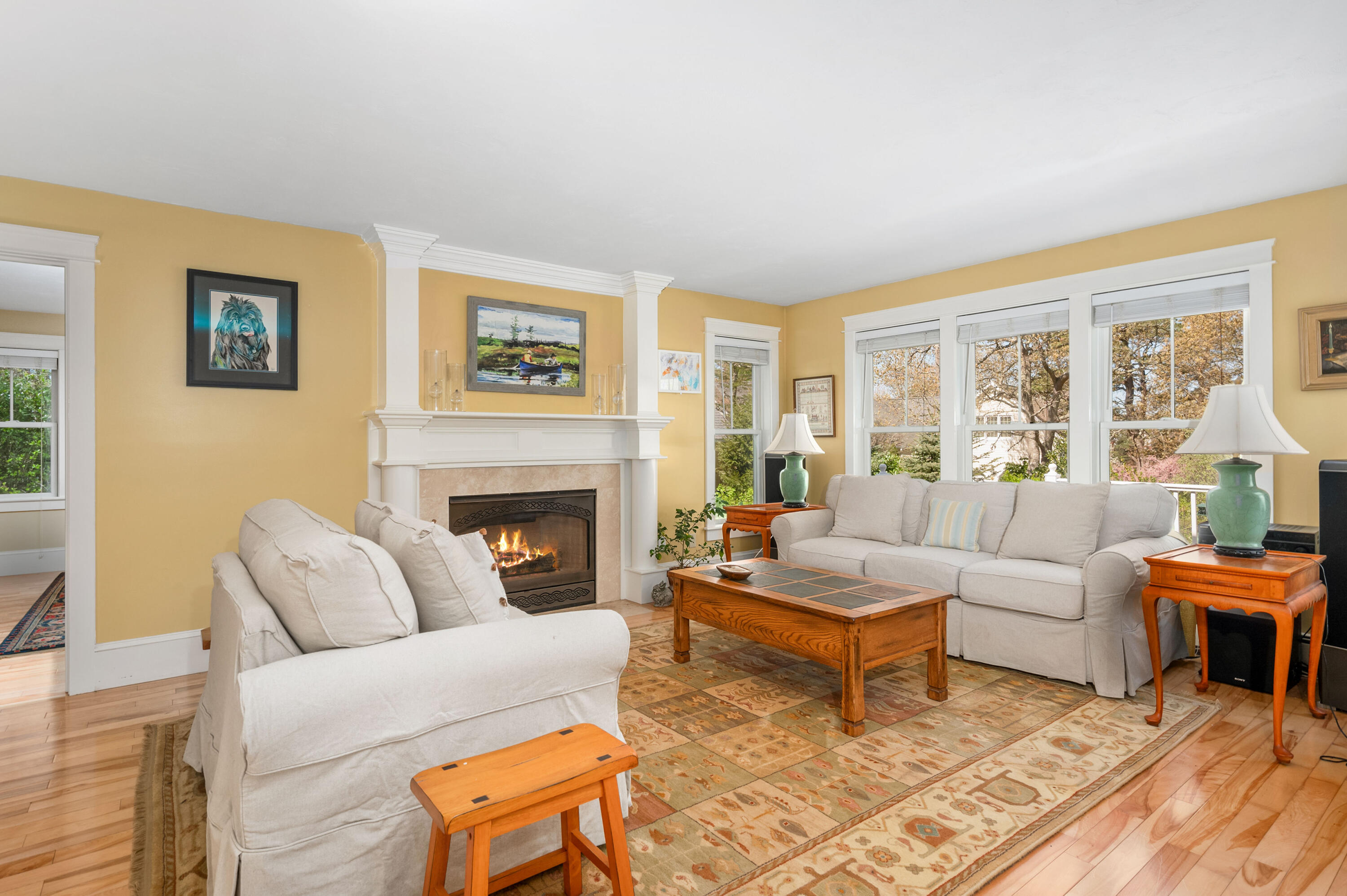 110 Clamshell Cove Road Cotuit, MA 02635 - Photo 7 of 56 a living room with furniture large window and a fireplace