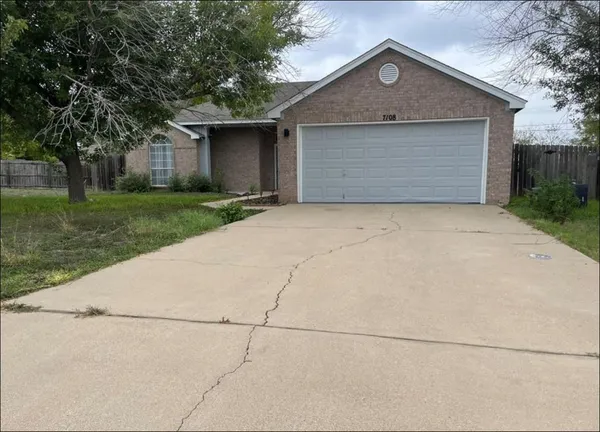 a front view of house with yard and trees