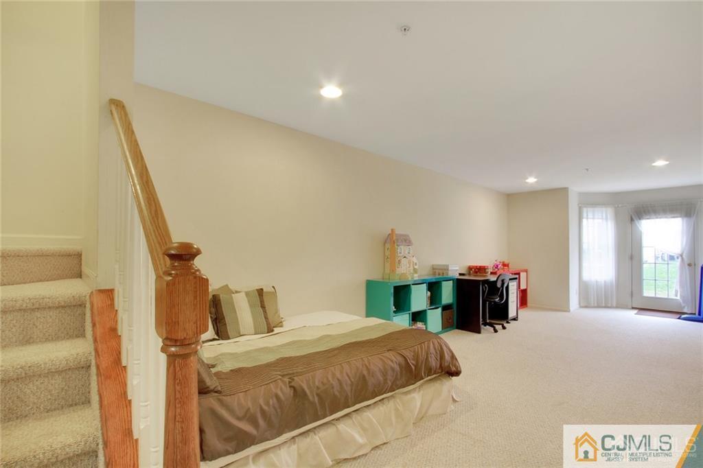 13 Raritan Reach Road, Unit 7 South Amboy, NJ 08879 - Photo 13 of 25 a bedroom with a bed and a large mirror on the dresser