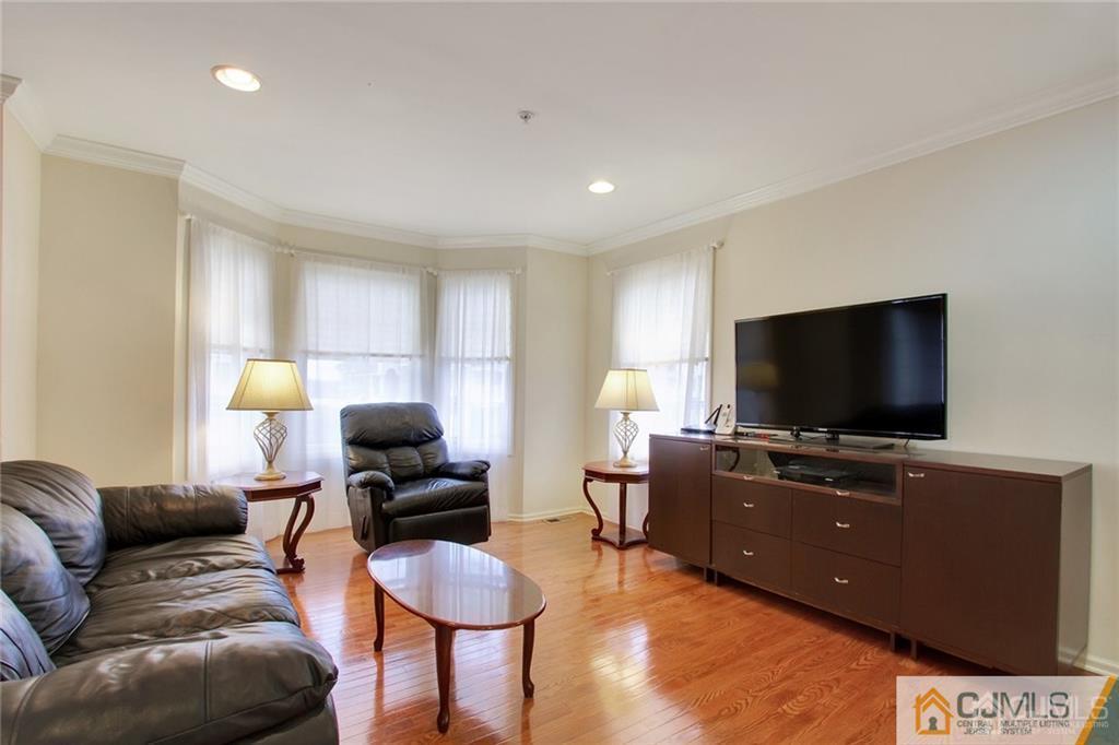 13 Raritan Reach Road, Unit 7 South Amboy, NJ 08879 - Photo 3 of 25 a living room with furniture and a flat screen tv