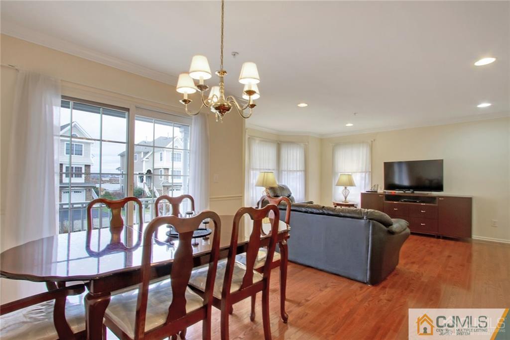 13 Raritan Reach Road, Unit 7 South Amboy, NJ 08879 - Photo 5 of 25 a view of a dining room with furniture window and wooden floor