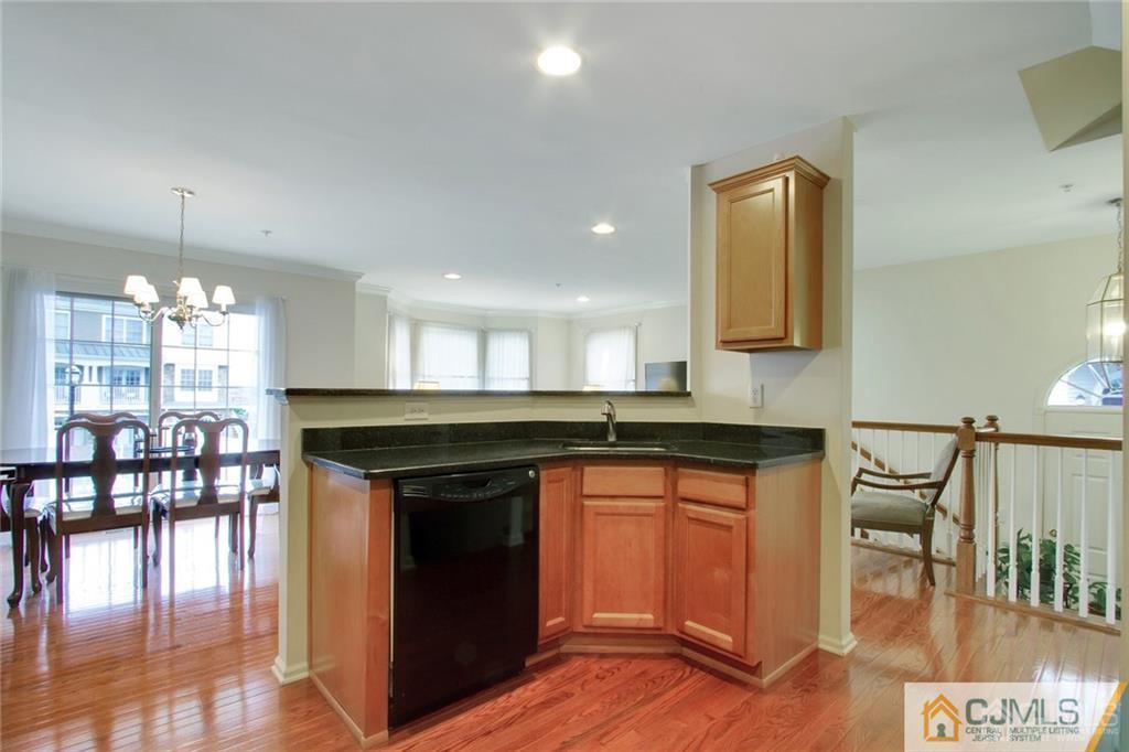 13 Raritan Reach Road, Unit 7 South Amboy, NJ 08879 - Photo 8 of 25 a kitchen with a sink cabinets and wooden floor