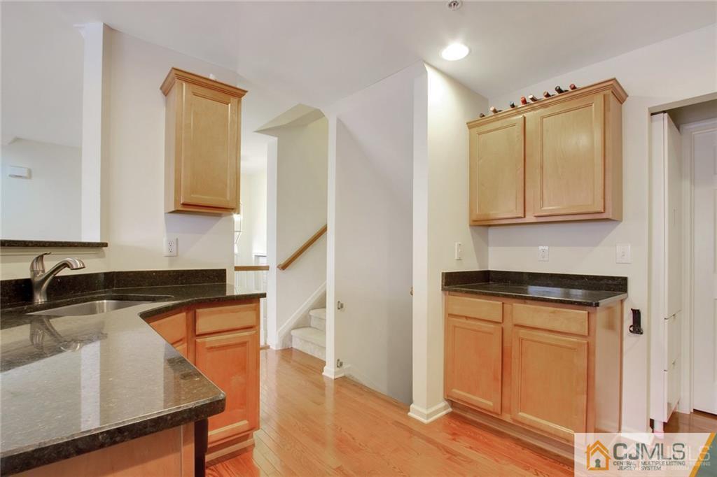 13 Raritan Reach Road, Unit 7 South Amboy, NJ 08879 - Photo 10 of 25 a kitchen with granite countertop a sink a stove and cabinets