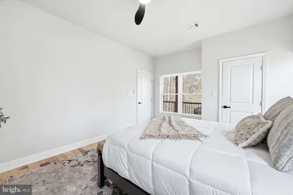 a bedroom with a bed and a painting on the wall