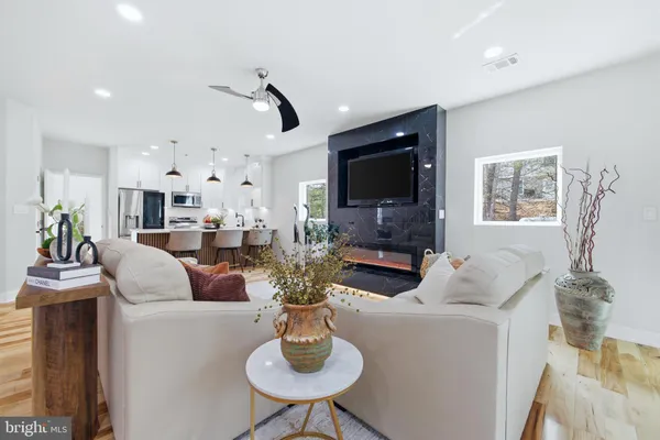 a kitchen with stainless steel appliances a table chairs refrigerator and microwave