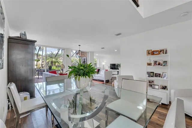 a dining room with furniture and a potted plant