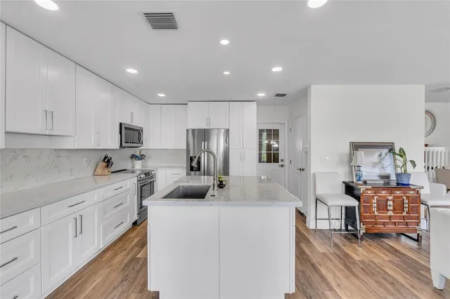 a kitchen with a sink stove and refrigerator
