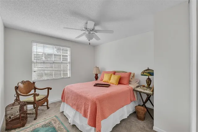 a bedroom with a bed and a potted plant