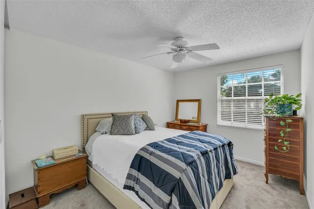 a bathroom with a granite countertop sink toilet and mirror